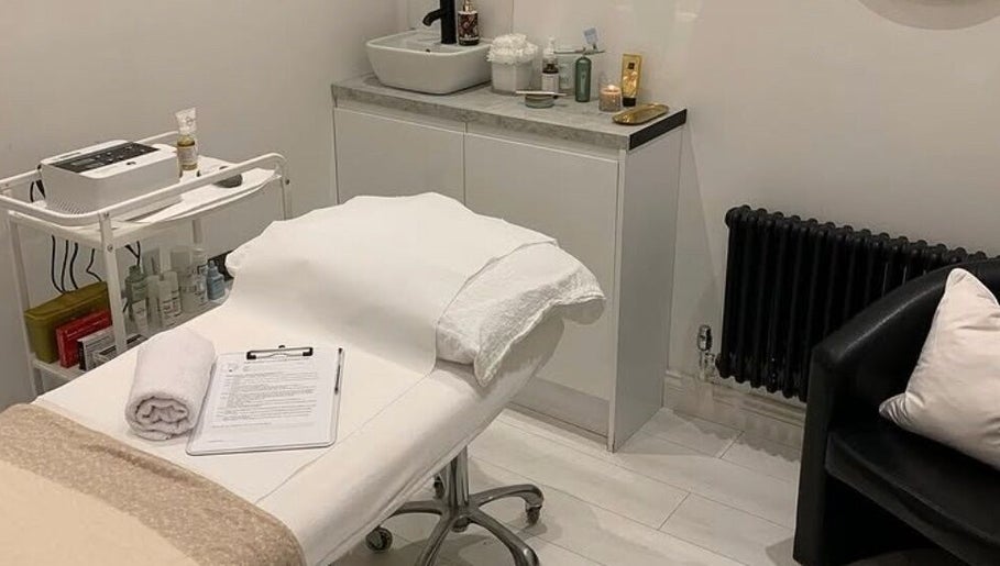 Elegant treatment room at Pure Esthetics in Chester, England, GB, featuring a cozy bed and skincare products.