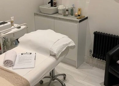 Elegant treatment room at Pure Esthetics in Chester, England, GB, featuring a cozy bed and skincare products.