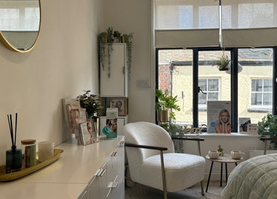 Cozy treatment room at Pure Esthetics, Chester, England, GB featuring chic decor and natural light.