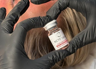 Close-up of a skincare vial held by gloved hands at Pure Esthetics, Chester, England, GB.