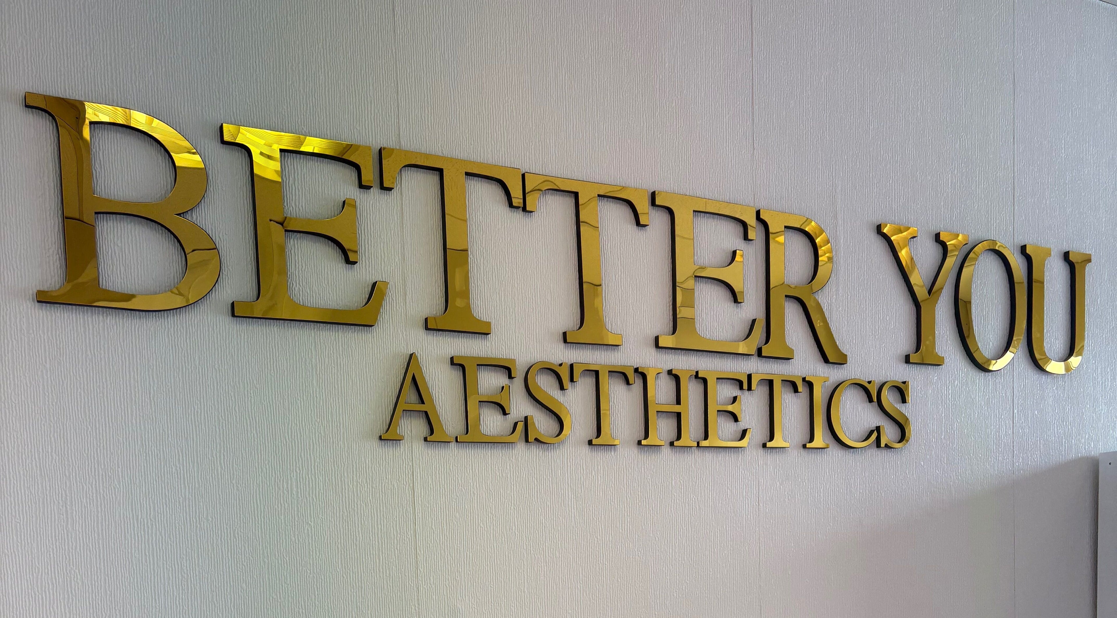 Gold sign of Better You Aesthetics in Finglas, County Dublin, IE on textured wall.