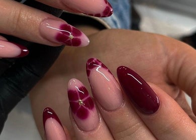 Elegant maroon and floral gel nails at Faith Nail'd It, Ebbsfleet Valley, England, GB.