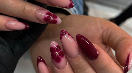 Elegant maroon and floral gel nails at Faith Nail'd It, Ebbsfleet Valley, England, GB.