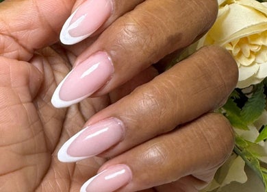 Elegant French manicure at Faith Nail'd It, Ebbsfleet Valley, England, GB. Perfectly shaped and polished nails.