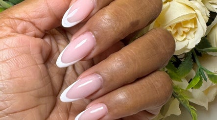 Elegant French manicure at Faith Nail'd It, Ebbsfleet Valley, England, GB. Perfectly shaped and polished nails.
