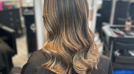 Elegant wavy hairstyle in warm tones at Hair by Ellie, Atherstone, England, GB salon.