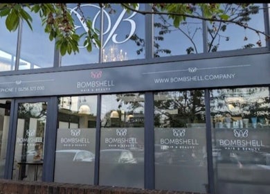 Exterior of Skin&Medics@Bombshell in Basingstoke, England, GB with large windows and logo.