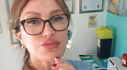 Professional holding syringe at Skin&Medics@Bombshell, Basingstoke, England, GB, showcasing expert care.