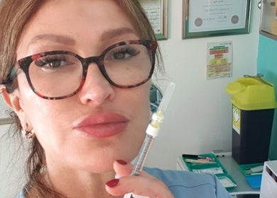 Expert at Skin&Wellness Medics@Bombshell in Basingstoke, England, GB holding a syringe in treatment room.