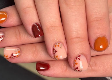 Autumn-themed nail art at A.Luxebeauty, Sheffield, England, GB, featuring warm colors and delicate designs.