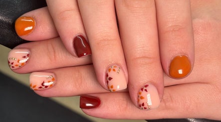 Autumn-themed nail art at A.Luxebeauty, Sheffield, England, GB, featuring warm colors and delicate designs.