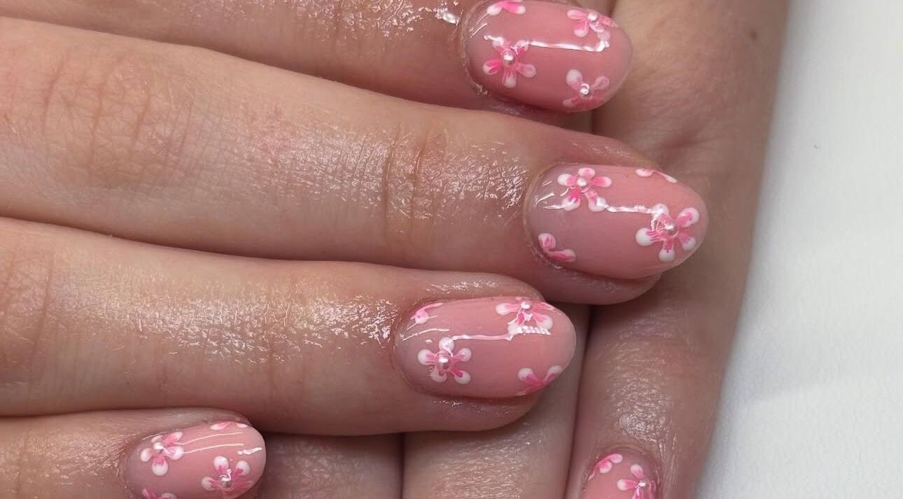 Elegant floral nail art at A.Luxebeauty, Sheffield, England, GB. Enhance style with delicate pink blooms.