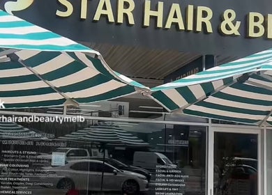 Front entrance of Star Hair and Beauty in Melbourne, Victoria, AU, showcasing the salon's signage and striped awnings.