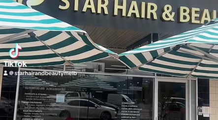 Front entrance of Star Hair and Beauty in Melbourne, Victoria, AU, showcasing the salon's signage and striped awnings.