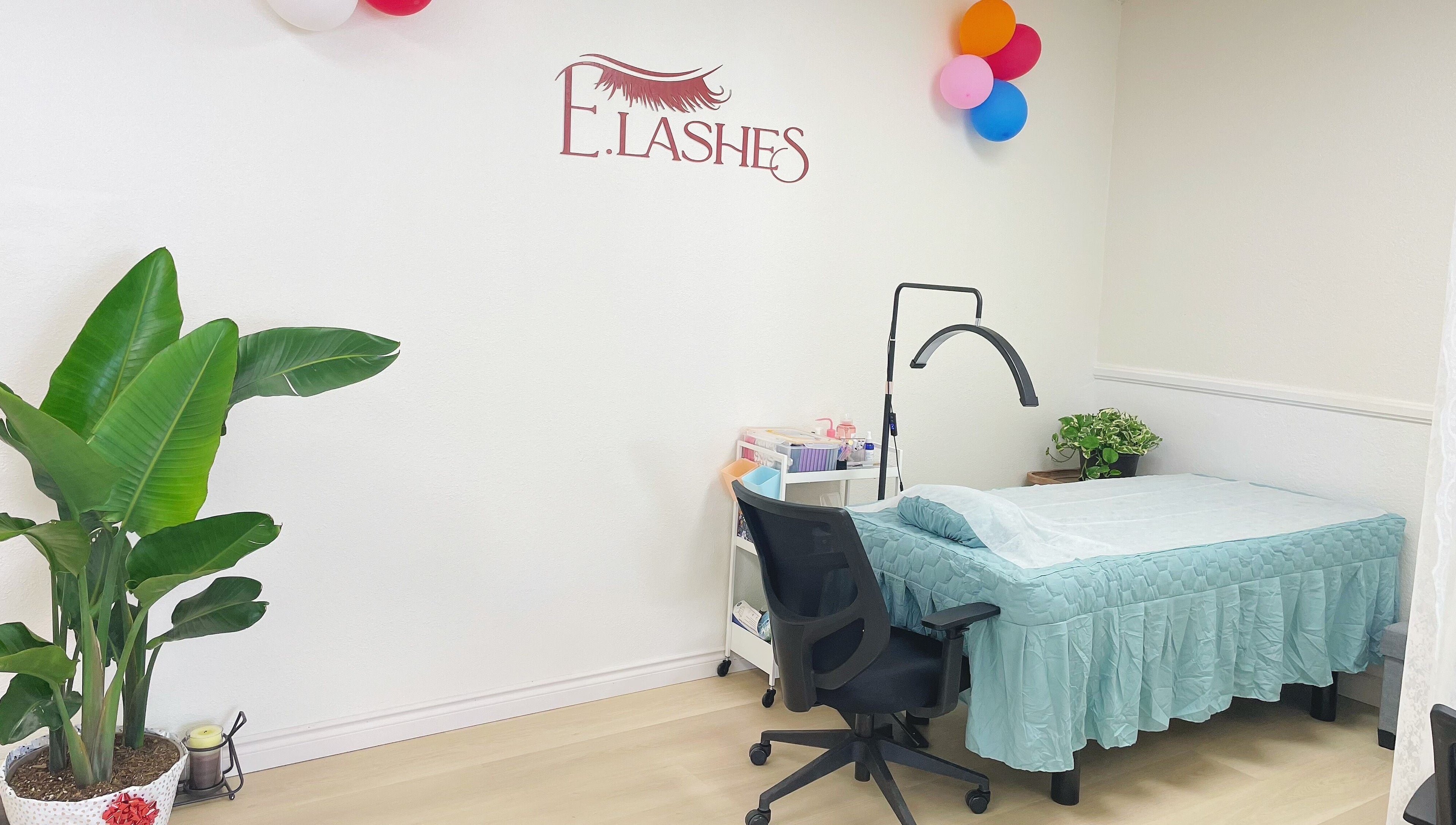 E.Lashes lash extension room in El Monte, California, US, with a treatment bed, chair, and decor.
