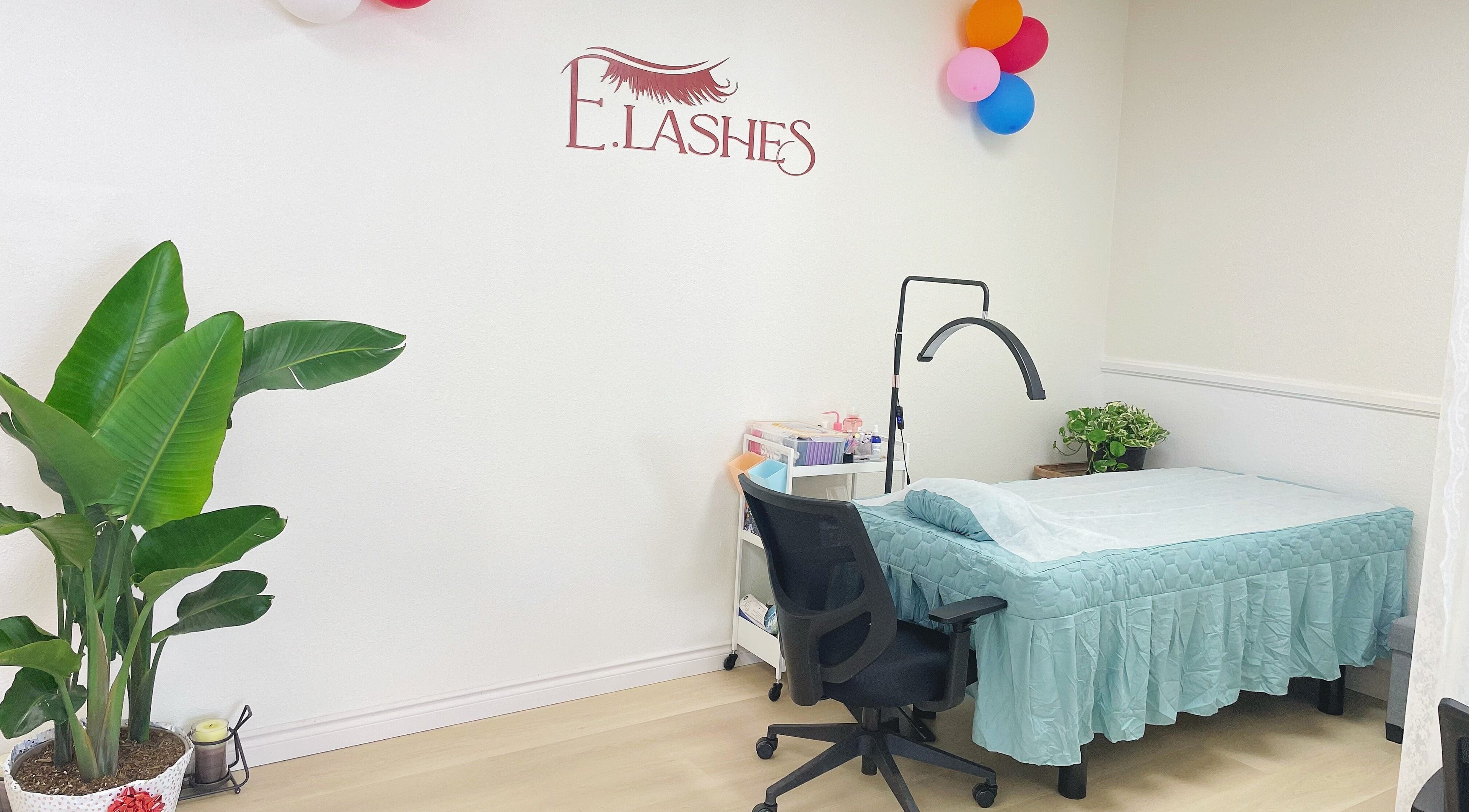 E.Lashes lash extension room in El Monte, California, US, with a treatment bed, chair, and decor.