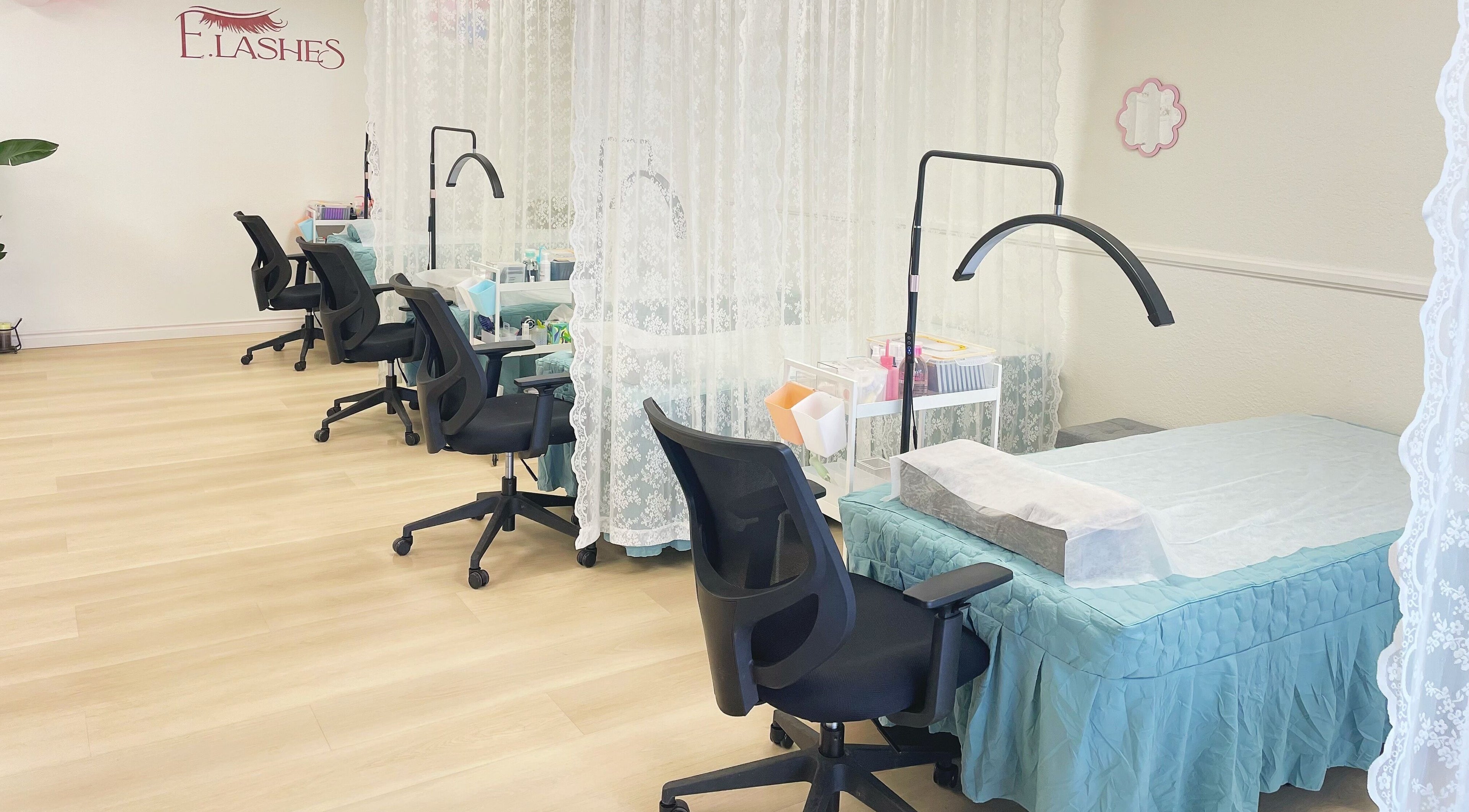 E.Lashes beauty setup with chairs and treatment beds in El Monte, California, US, offering a serene ambiance.