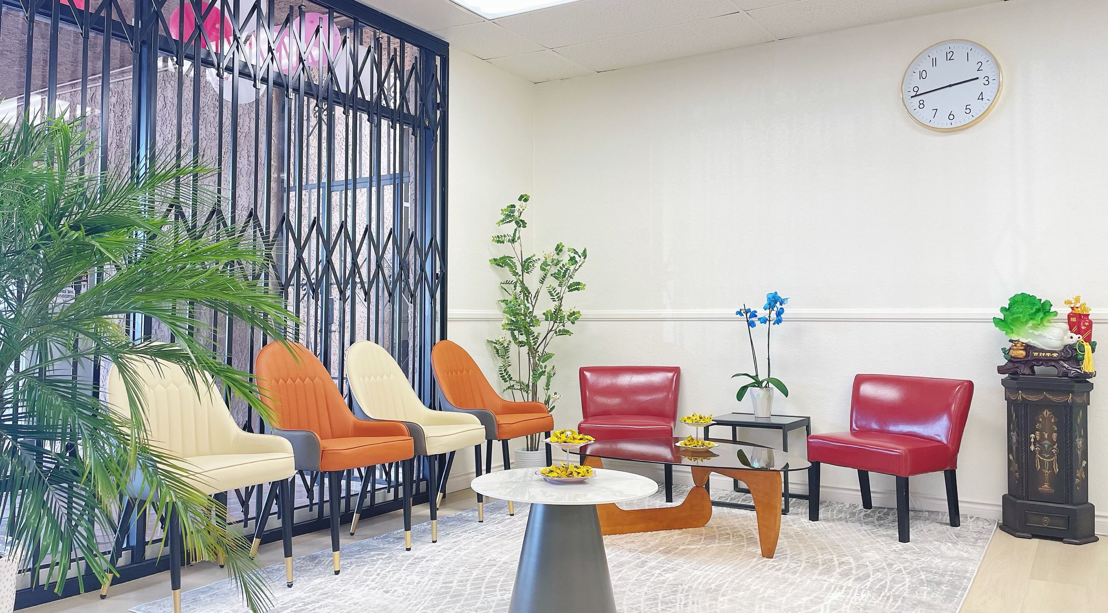 Stylish waiting area at E.Lashes, El Monte, California, US with modern chairs and lush greenery.