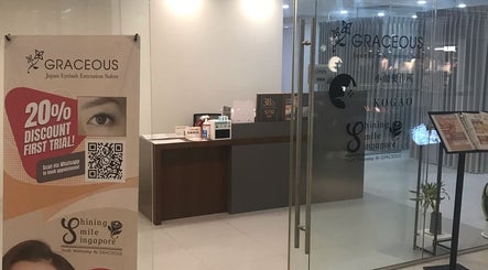 Entrance to Shining Smile Singapore in Singapore, SG showing a modern lobby with promotional banner.
