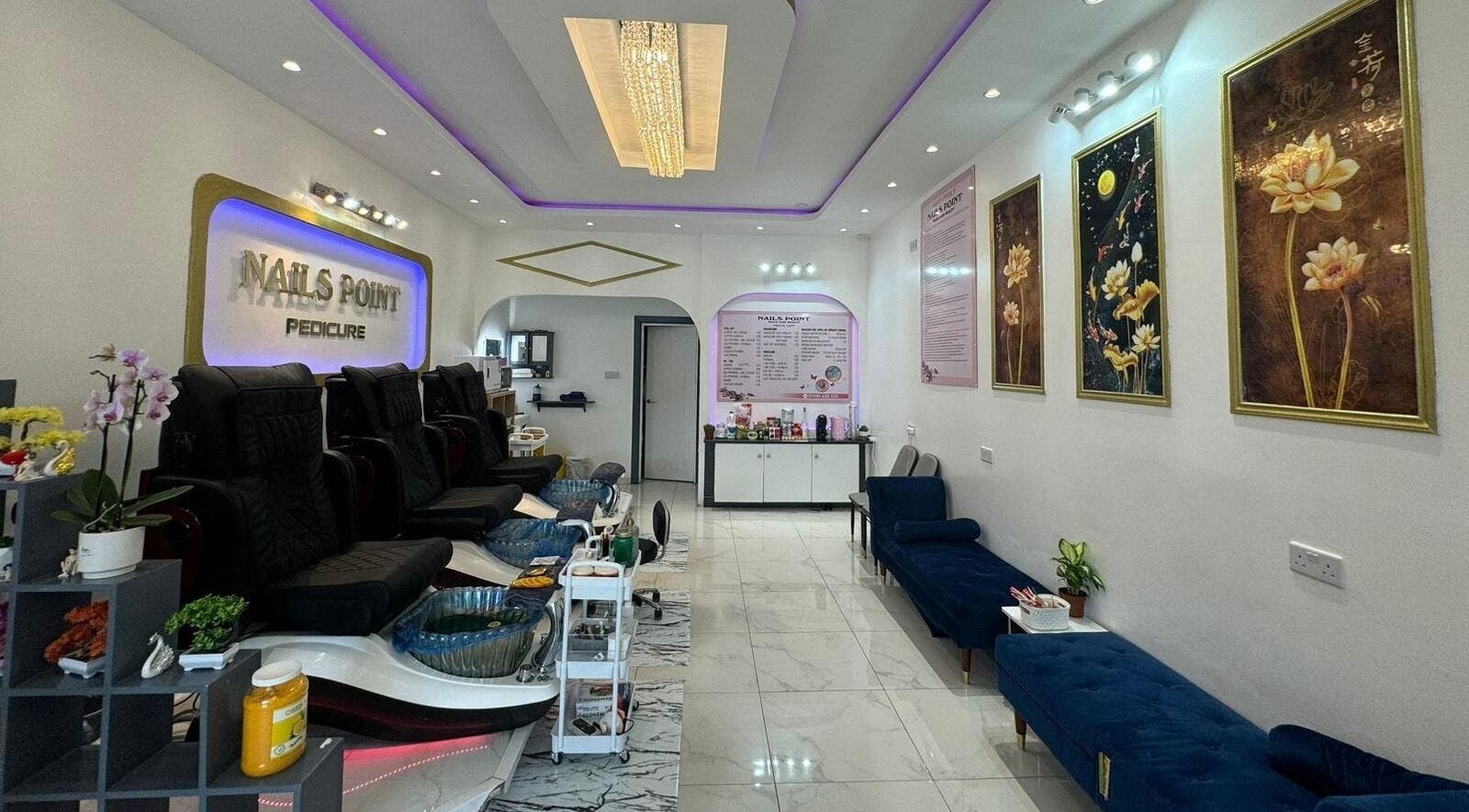 Modern interior of Nails Point, a beauty venue in London, England, GB with elegant decor and comfortable chairs.