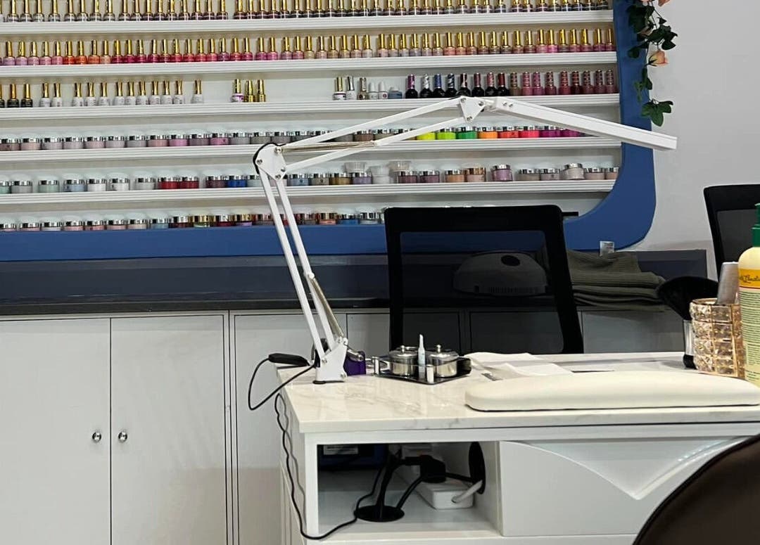 Nails Point, London, England, GB: A vibrant nail salon with an array of polish colors on display.
