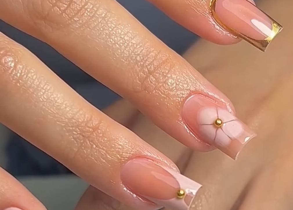 Elegant nail art with gold accents at Nails Point, London, England, GB. Perfect for showcasing style.