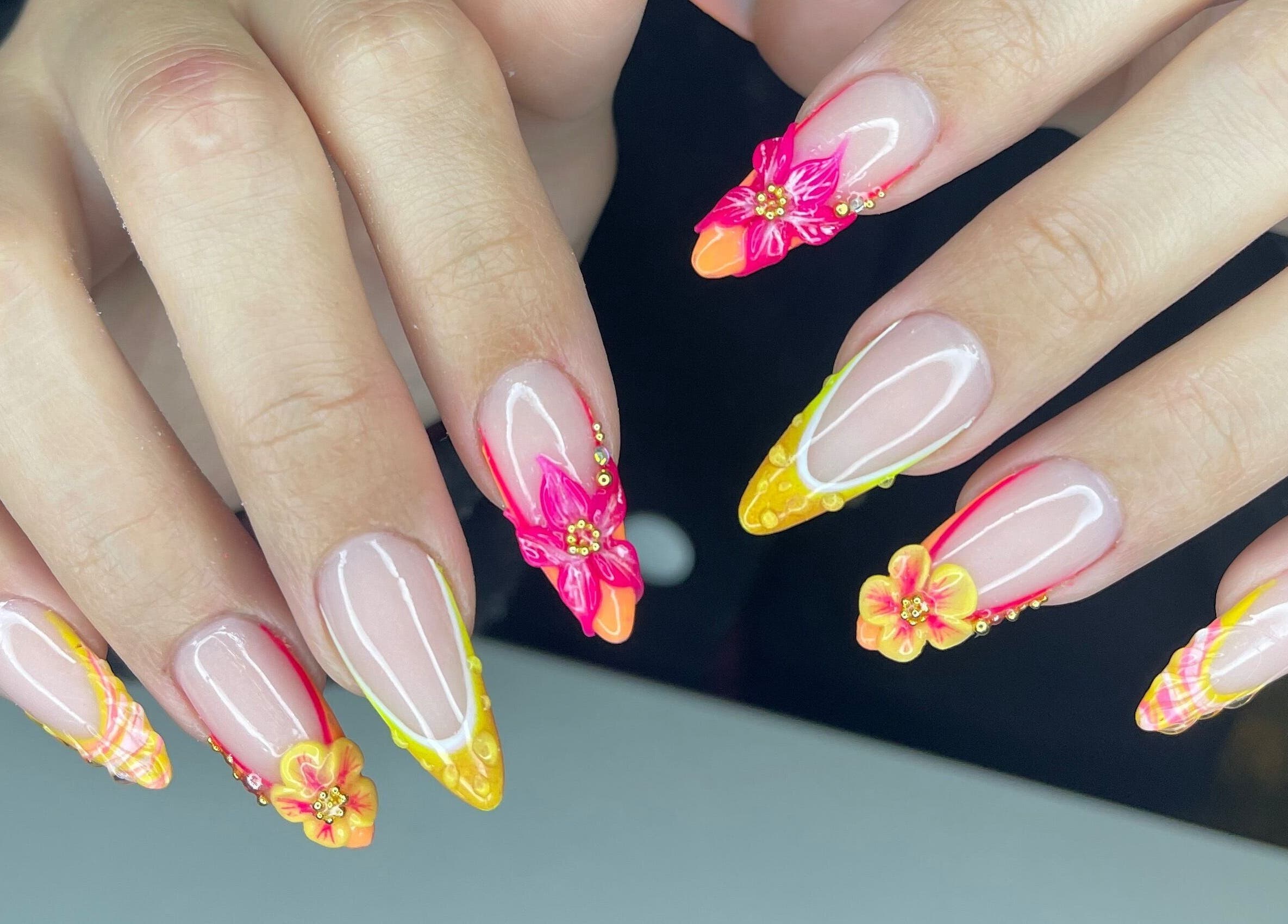 Vibrant floral nail art at Nails Point, London, England, GB, showcasing detailed and colorful designs.