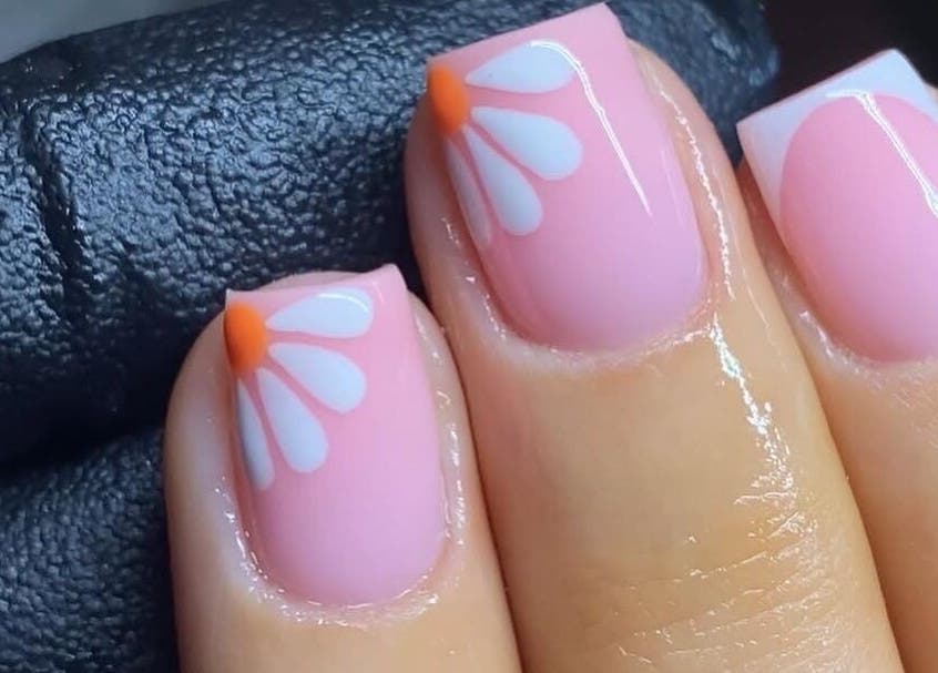 Floral nail art at Nails Point, London, England, GB showcasing intricate pink and white designs.