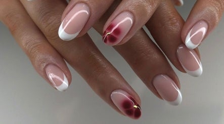 Manicured hands with white tips and floral art at Mashed Nails, Melbourne, Victoria, AU.