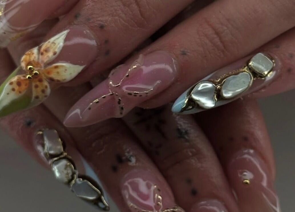 Close-up of intricate nail art design at Mashed Nails, Melbourne, Victoria, AU showcasing floral and gem details.