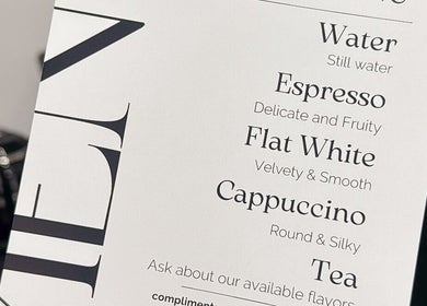 Beverage menu at Rituals By Nanda, Praha, CZ offering espresso, flat white, cappuccino, water, and tea.