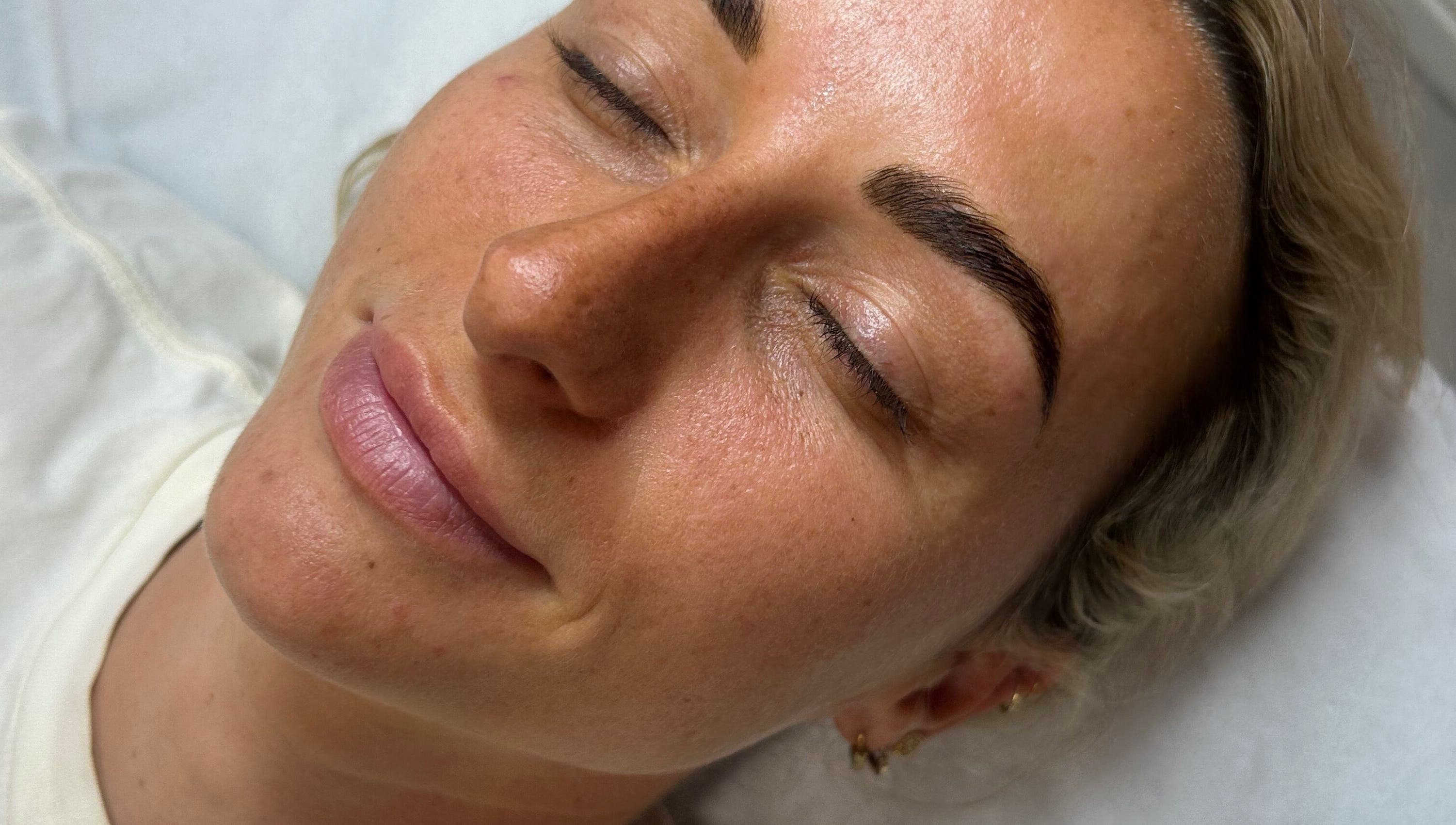 Client enjoys a serene moment after treatment at Lilly Hoffmann permanent cosmetics, Brynhyfryd, Wales, GB.