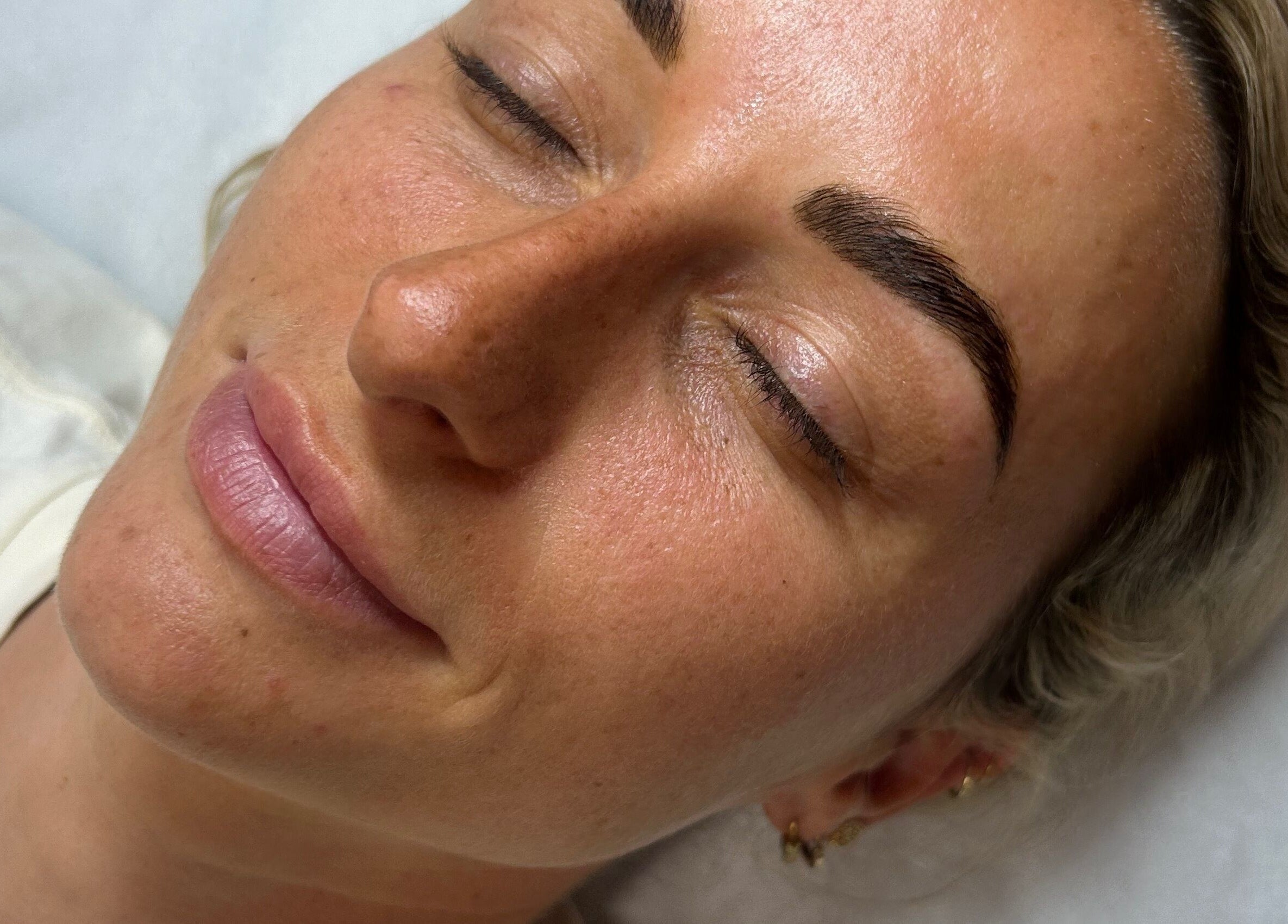 Client enjoys a serene moment after treatment at Lilly Hoffmann permanent cosmetics, Brynhyfryd, Wales, GB.