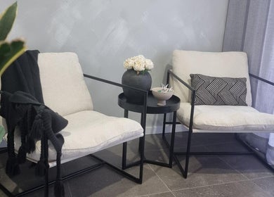 Elegant seating area at Belle Luxe, Oakford, Western Australia, AU, featuring plush chairs and decor.