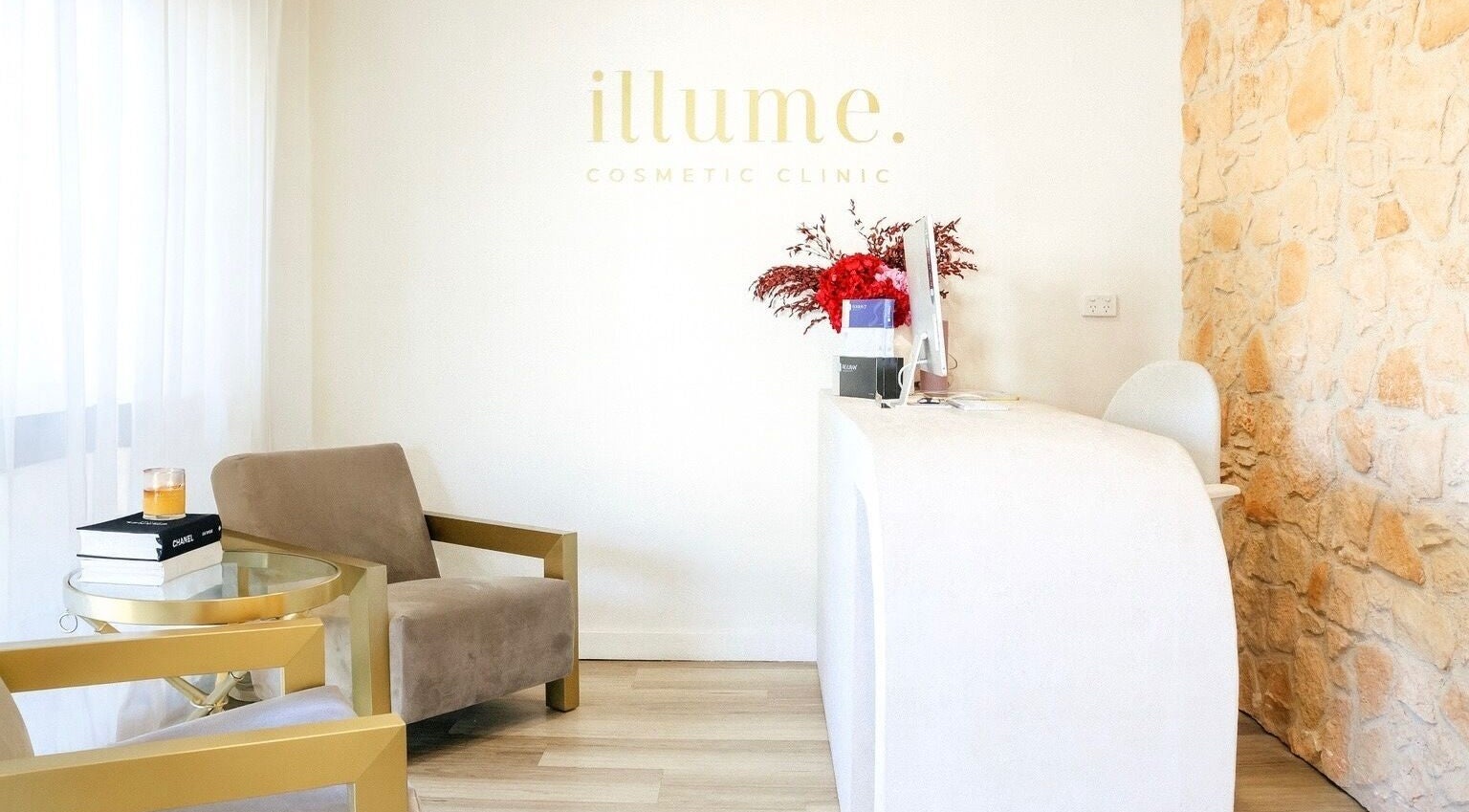 Illume Cosmetic Clinic reception with cozy seating in Clayfield, Queensland, AU.