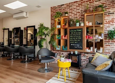 Relaxed seating and styling area at Care Salon, London, England, GB with vibrant decor and modern chairs.