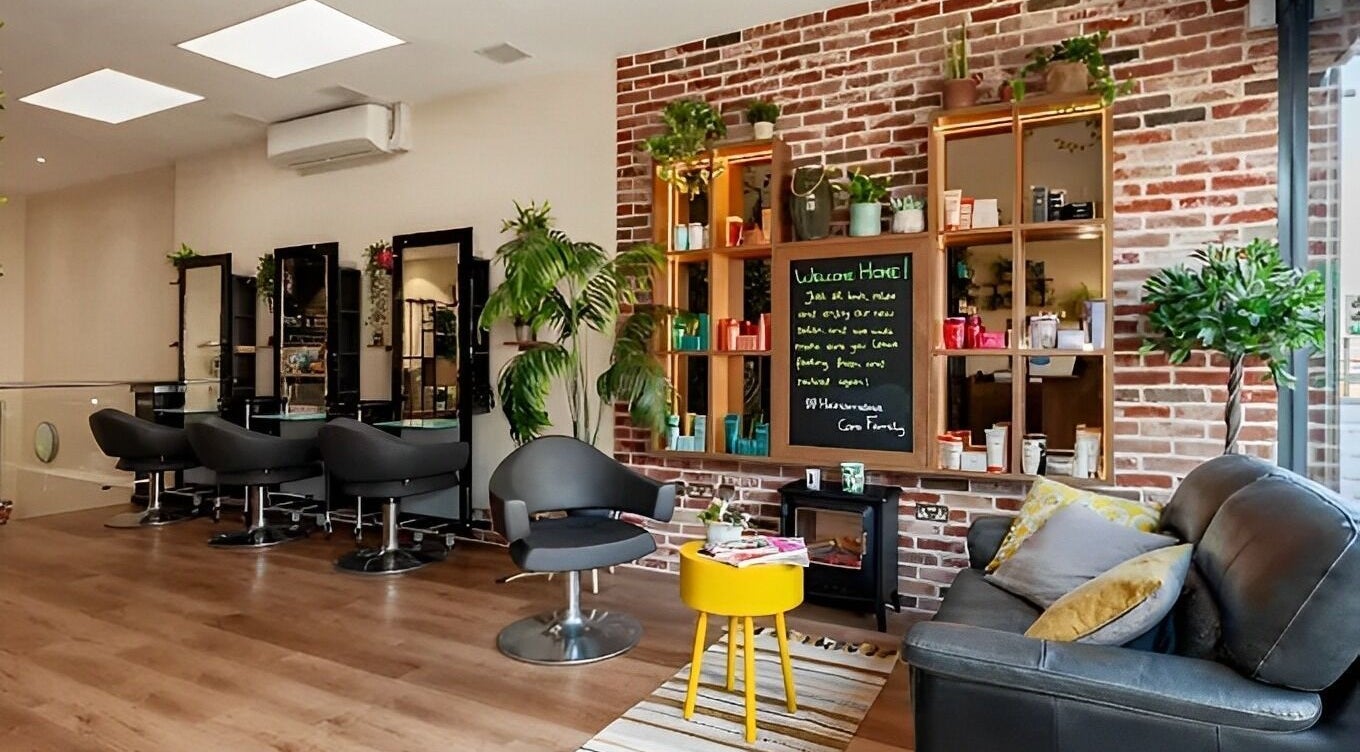 Relaxed seating and styling area at Care Salon, London, England, GB with vibrant decor and modern chairs.