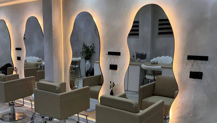 Elegant seating and wavy mirrors at Custom Skin Studio in Swinton, England, GB.