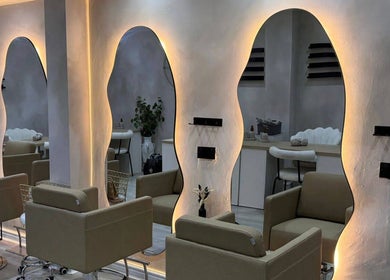 Elegant seating and wavy mirrors at Custom Skin Studio in Swinton, England, GB.