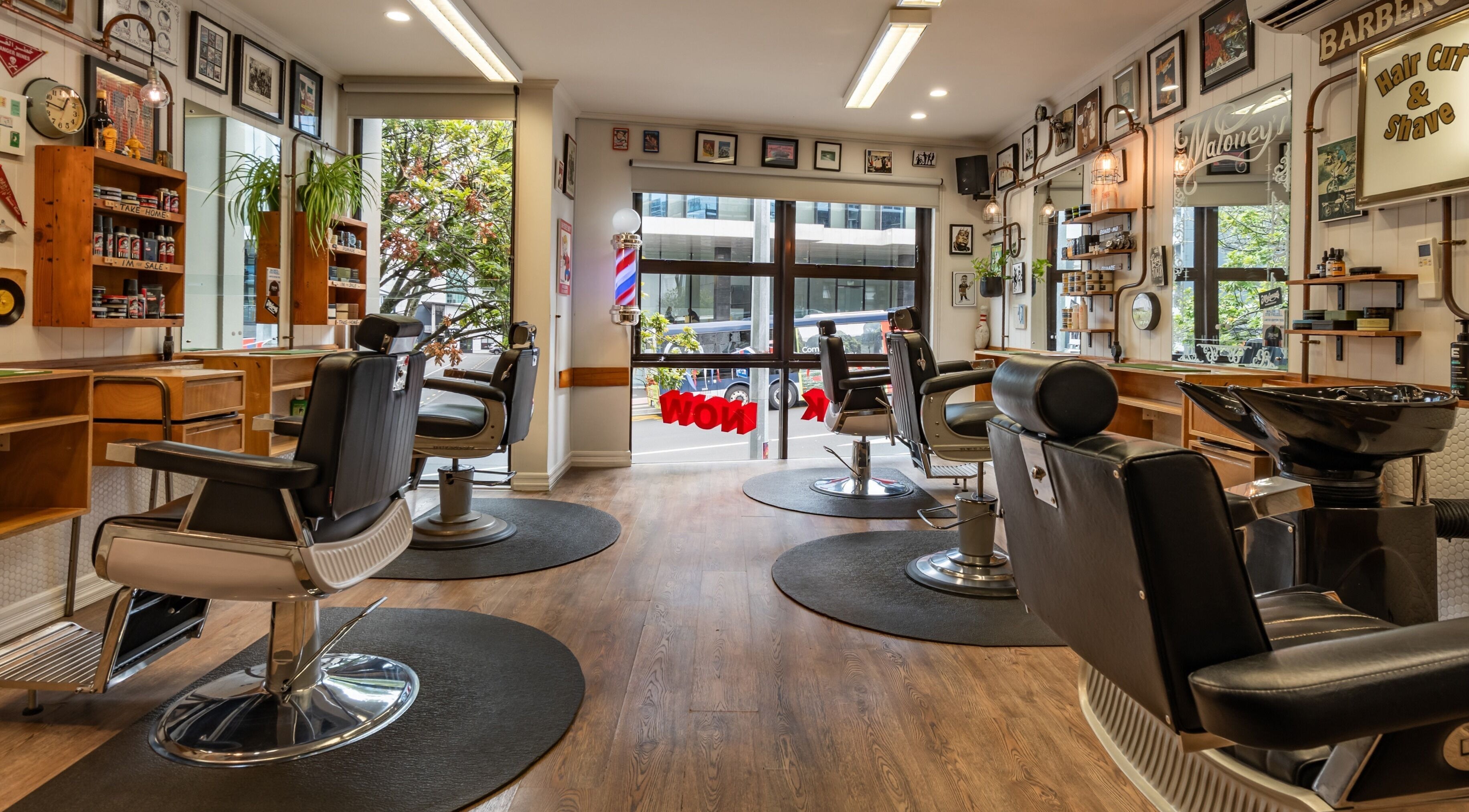 Interior of Maloney's Barber Shop in Auckland, NZ featuring stylish barber chairs and vintage decor.