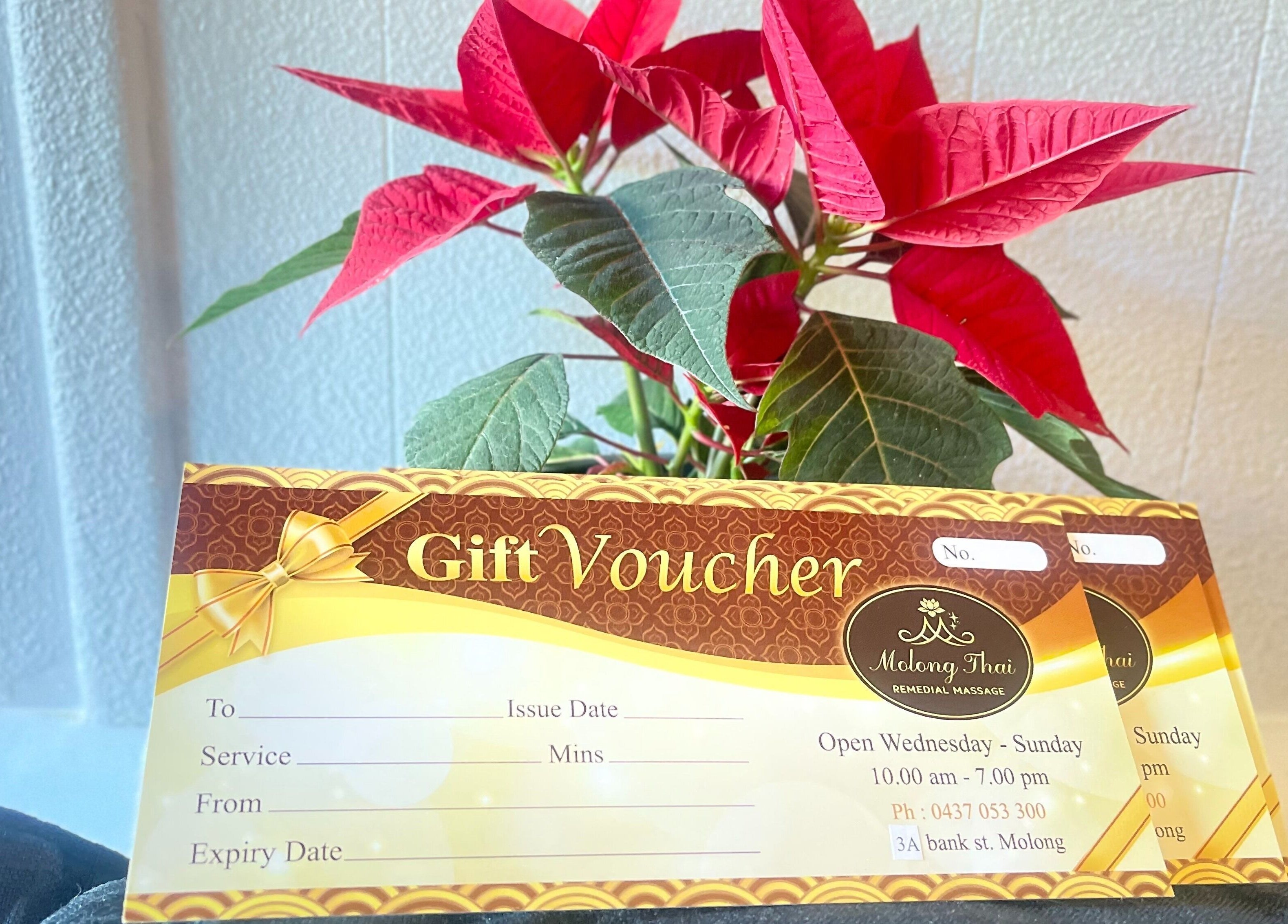Gift voucher from Molong Thai Remedial Massage in Molong, New South Wales, AU, displayed with red flowers.