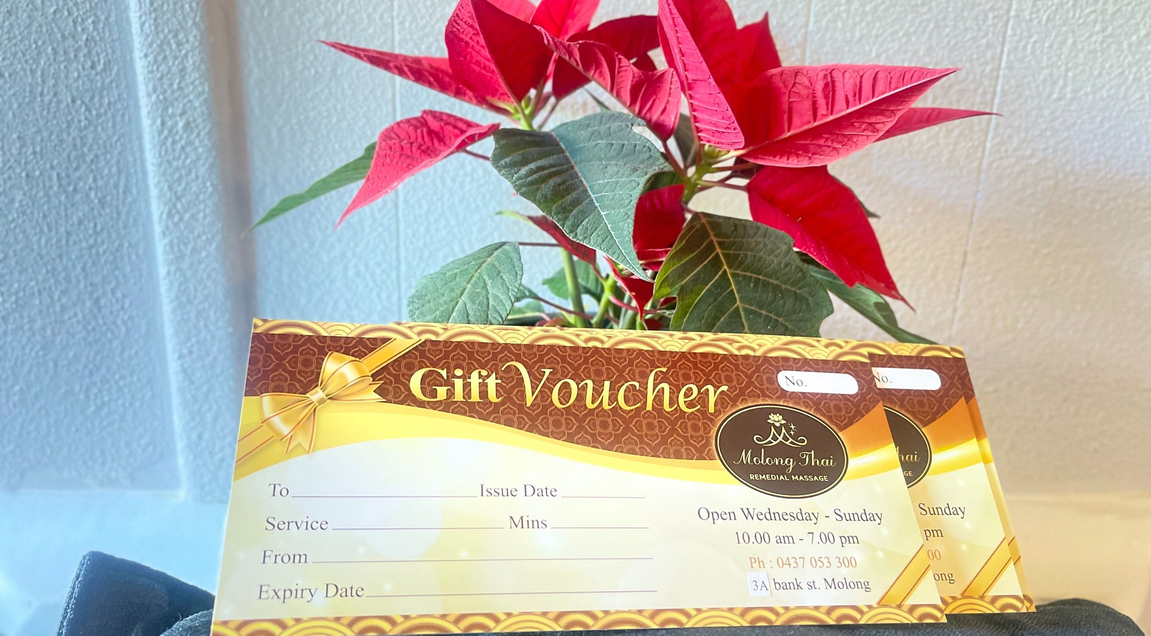 Gift voucher from Molong Thai Remedial Massage in Molong, New South Wales, AU, displayed with red flowers.