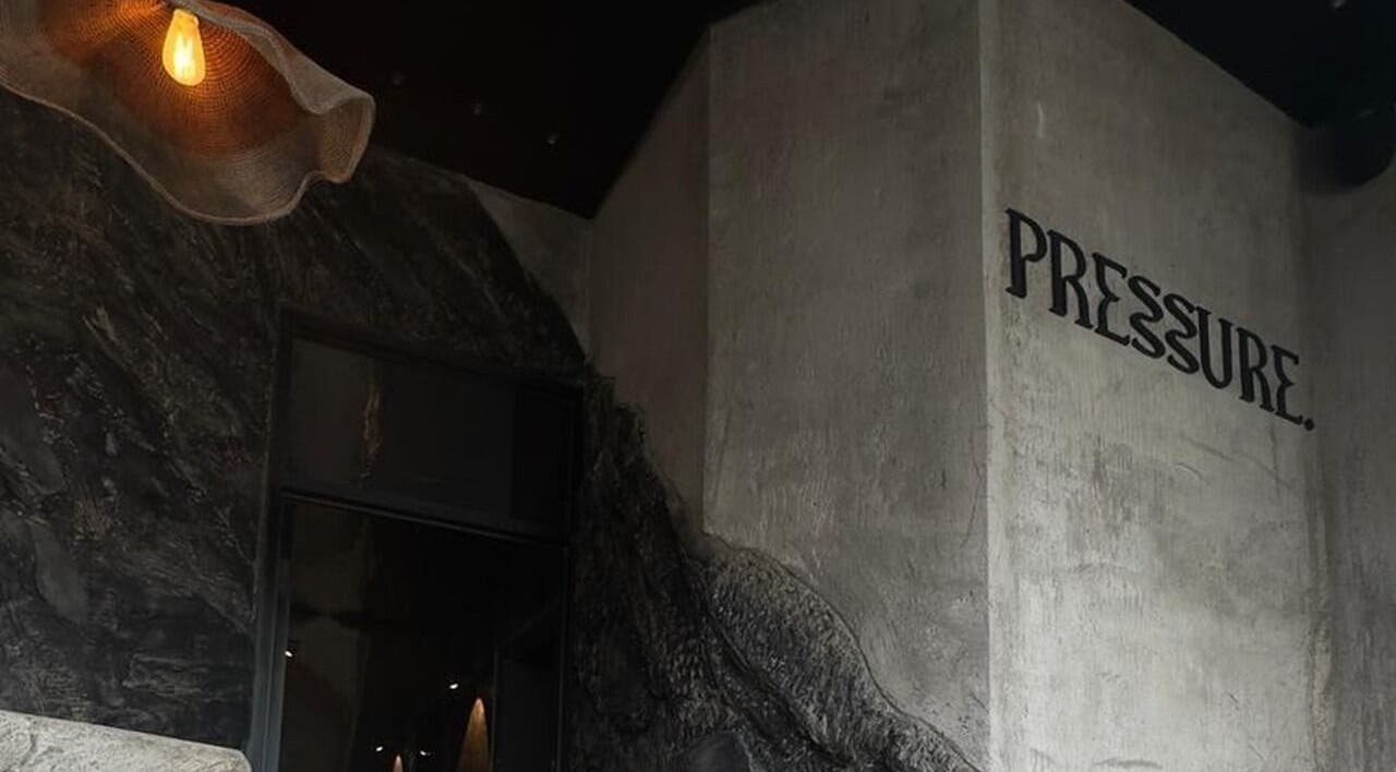 Entrance of Pressure. Massage Spa Bali in Bali, ID with artistic wall design and warm lighting.