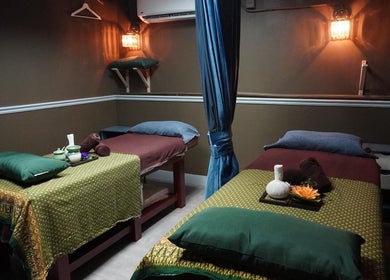 Cozy massage room at Siam Thai Massage & Spa in HK, HK, featuring two massage tables with warm lighting.