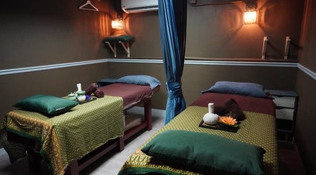 Cozy massage room at Siam Thai Massage & Spa in HK, HK, featuring two massage tables with warm lighting.