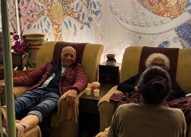 Guests enjoying a relaxing foot massage at Siam Thai Massage & Spa, HK, HK with vibrant decor and cozy chairs.