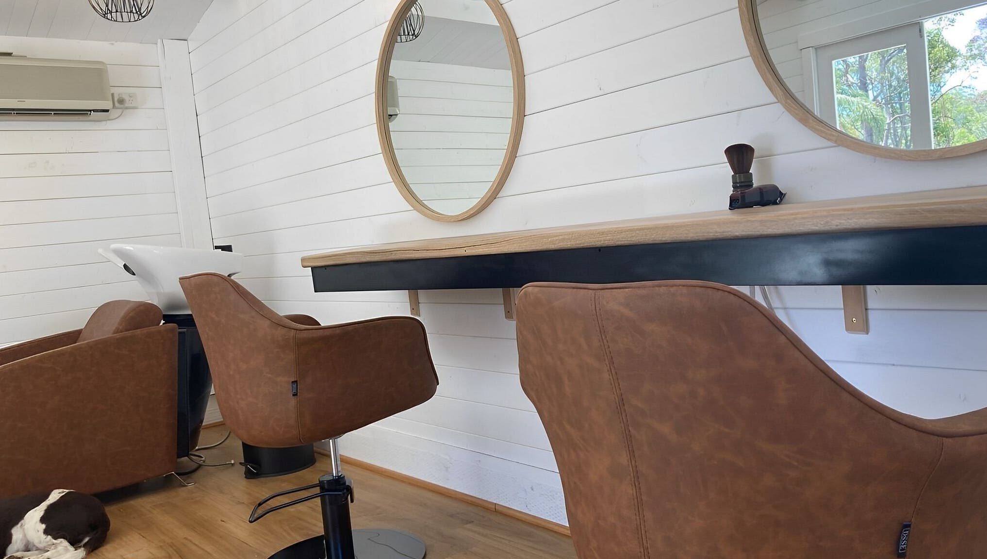 Modern salon interior at Smiths Lake Hair Studio, Smiths Lake, New South Wales, AU with stylish chairs and mirrors.