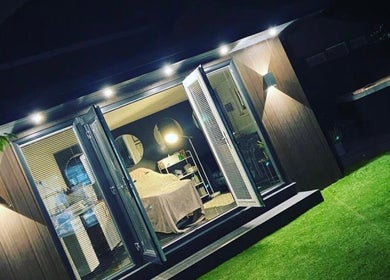 Cozy treatment room at Anike Aesthetics & Beauty in Radcliffe, England, GB, beautifully illuminated at night.