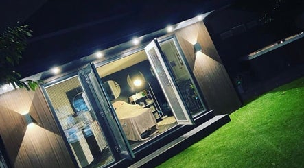 Cozy treatment room at Anike Aesthetics & Beauty in Radcliffe, England, GB, beautifully illuminated at night.