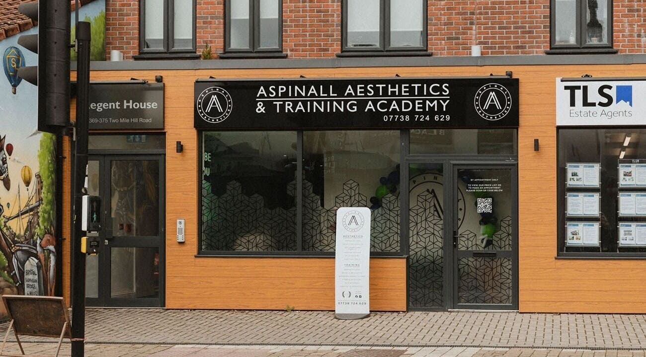 Front view of Aspinall Aesthetics in Kingswood, England featuring modern signage.